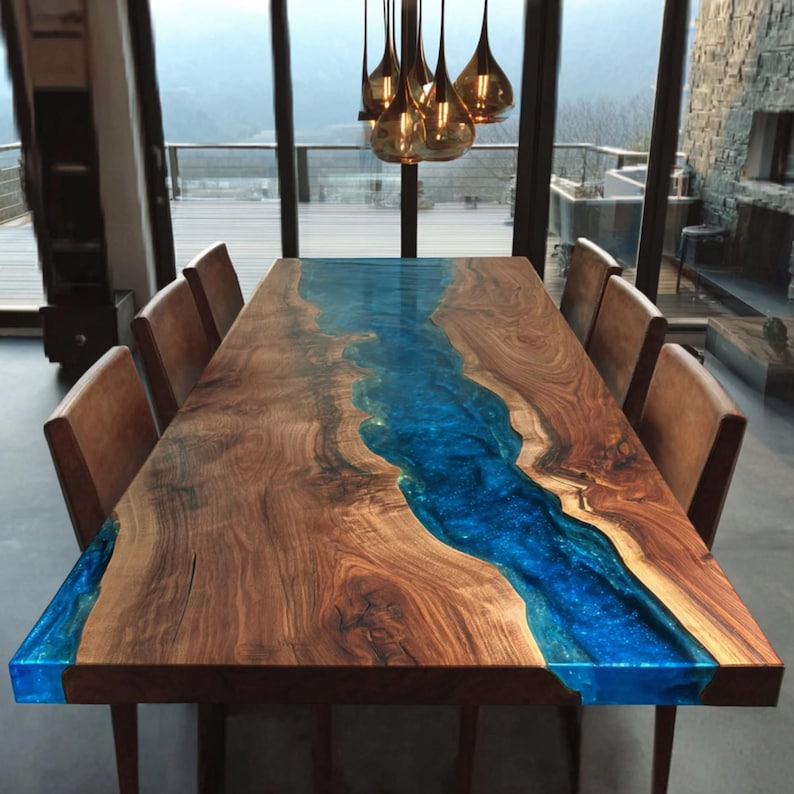 May include: A large, rectangular wooden dining table with a vibrant blue resin river running through the center. The table is surrounded by brown leather chairs. The table is approximately 100 inches long.