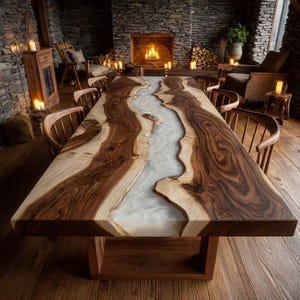 May include: A large, handcrafted wooden dining table with a unique design. The table features a river of white resin flowing through the center, framed by rich, dark brown wood. The table is supported by a sturdy wooden base, creating a striking centerpiece.