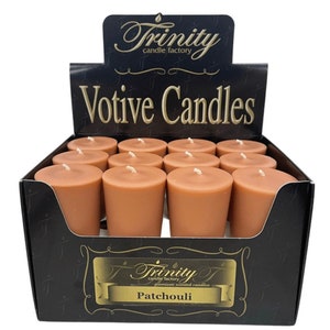 May include: A box of 12 brown votive candles with the text "Trinity candle factory" and "Votive Candles" on the front. The box also has a label on the bottom that says "Patchouli".