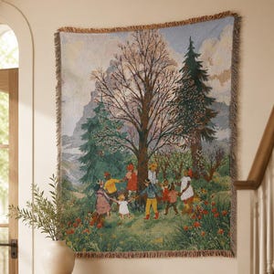 May include: A woven wall tapestry featuring a colourful landscape scene with a group of children holding hands in a circle around a large central tree. The scene includes evergreen trees, mountains in the background, and red flowers in the foreground.