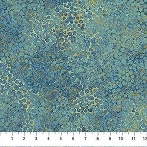 May include: A close-up of fabric featuring a repeating pattern of small, textured circles in shades of blue and teal, with gold accents. The fabric is measured with a ruler in inches, showing a width of approximately 30.5 cm.