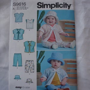 May include: Simplicity sewing pattern S9616 for baby clothing. The pattern includes options for tops, pants, and hats. The cover features two babies wearing the outfits. The text "easy-to-sew" is printed on the bottom of the pattern.