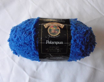 May include: A blue ball of Polarspun yarn, a soft, chunky yarn perfect for the whole family. The label reads "Our Quality Shows" and "Polarspun".
