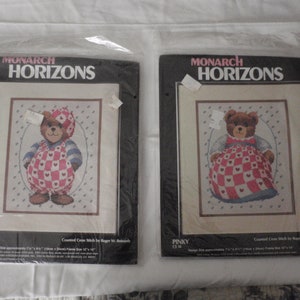 Op de afbeelding: Twee getekende kruissteekpatronen met een teddybeer die een rood-wit geruit jurkje draagt. De patronen zijn getiteld "P.J. Bear" en "Pinky" en zijn van Monarch Horizons.