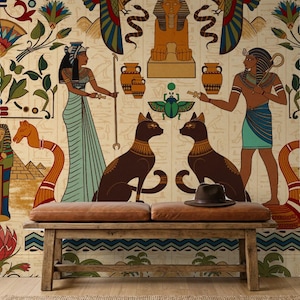 May include: A rectangular wooden bench with a brown leather cushion sits in front of a wall mural featuring ancient Egyptian motifs, including a sphinx, pyramids, two cats, a scarab, and figures of a woman and a man in traditional attire.