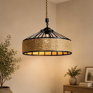 May include: A rustic pendant light with a black metal frame and a woven rope shade. The light hangs from a thick rope and features a warm, inviting glow. The design is reminiscent of farmhouse or coastal decor.