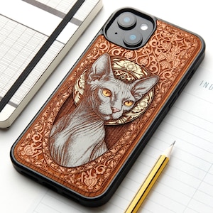 May include: A black smartphone case featuring a wood-toned back panel with an intricate, laser-engraved design of a Sphynx cat. The cat is centered within an ornate, circular floral frame, surrounded by detailed scrollwork and filigree patterns.