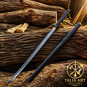 May include: A katana sword with a patterned steel blade, a black wrapped handle, and a gold-colored guard, accompanied by a matching black textured scabbard. The sword is positioned diagonally, featuring a sharp point and a visible hamon line.