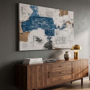 May include: A rectangular wall art piece featuring layered architectural blueprints in blue, white, and tan. The design includes technical drawings, structural sketches, and the text A2.1, layered with textured paint strokes and abstract markings.