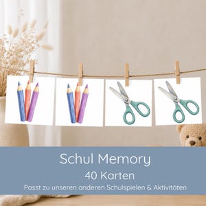 May include: A set of 40 memory cards titled Schul Memory, featuring illustrations of colored pencils and scissors. The cards are displayed hanging from a string with wooden clips. The text on the image reads Schul Memory 40 Karten.