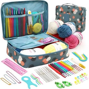 May include: A dark teal floral storage case containing various crochet supplies, including colorful ergonomic crochet hooks, metal needles, yarn balls in white, blue, and pink, a pink plastic knitting gauge, and assorted stitch markers.