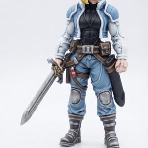 May include: A blonde action figure wearing a light blue and white jacket over a black bodysuit, light blue pants with knee pads, and dark boots. The figure holds a silver sword in one hand and has a black scabbard attached to a brown utility belt.