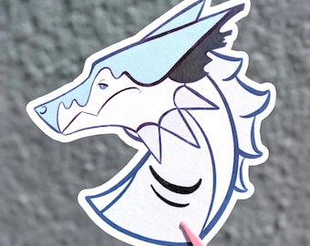 May include: A die-cut sticker featuring a stylised illustration of a wolf head in profile. The design uses a palette of white, light blue, and dark blue outlines, with a sharp, angular aesthetic and a pointed ear. The wolf has a calm expression.
