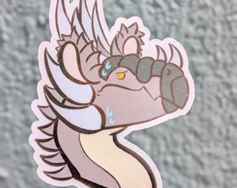 May include: A die-cut sticker featuring a stylised dragon head in profile. The dragon has light purple skin, a cream-coloured neck, dark grey snout plating, and light blue horns. It has yellow eyes and blue sweat drop icons on its face.