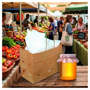 May include: A brown paper shopping bag with white tissue paper inside sits next to a jar of honey with a pink cloth cover. The background shows a farmer's market with produce and people.