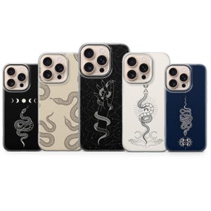 May include: Five smartphone cases featuring various white line art designs on black, beige, white, and dark blue backgrounds. The illustrations include snakes, celestial moon phases, constellations, hands, and sun motifs, all arranged in a row.