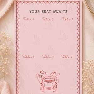 May include: A pink wedding seating chart with a red scalloped border. The text "YOUR SEAT AWAITS" is at the top, with table numbers below. A red car with heart balloons is at the bottom. The background is a soft pink.
