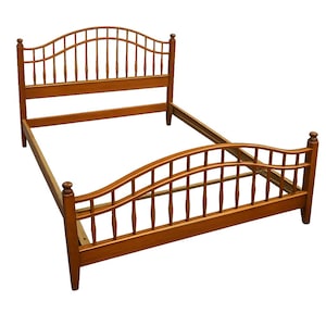 May include: A wooden bed frame with a headboard and footboard. The frame is made of light brown wood and features a curved headboard and footboard design with vertical spindles. The bed frame is empty and ready for a mattress.