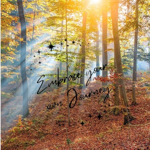 May include: A forest scene during autumn with golden sunlight filtering through tall trees and fallen brown leaves on the ground. The black text "Embrace your own Journey" is centered, surrounded by small black star and sparkle icons.