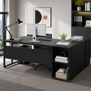 May include: An L-shaped office desk with a dark gray marble-patterned top and a black metal frame. The desk features an integrated side storage unit with two open shelves containing books and a woven basket, a black privacy panel, and a computer monitor.