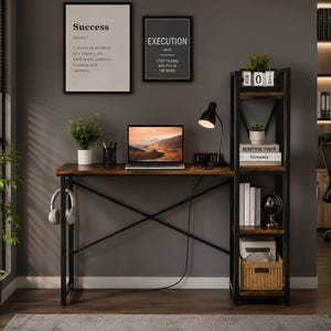 May include: A home office setup featuring a wooden desk with a black metal frame, a laptop, and a black desk lamp. A bookshelf with books, a globe, and a woven basket is to the right. Two framed prints with the words "Success" and "Execution" hang on the wall.