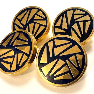 May include: Four circular buttons featuring a dark navy blue enamel background with a metallic gold geometric pattern of scattered triangles. Each button has a polished gold-tone rim and a flat, circular face with a smooth finish.