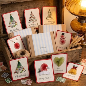 May include: A DIY kit for string art Christmas cards featuring various designs like trees, a reindeer, a snowman, a Santa hat, a heart, and a bell. The cards include text such as Merry Christmas, Happy Holidays, and Ho Ho Ho.