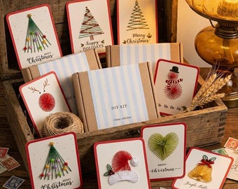 May include: A DIY kit for string art Christmas cards featuring various designs like trees, a reindeer, a snowman, a Santa hat, a heart, and a bell. The cards include text such as Merry Christmas, Happy Holidays, and Ho Ho Ho.