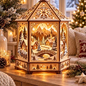 May include: A hexagonal wooden lantern featuring an illuminated winter village scene with snow-covered houses, pine trees, a bridge, and mountain peaks. The structure has intricate laser-cut snowflake patterns on the roof and base.