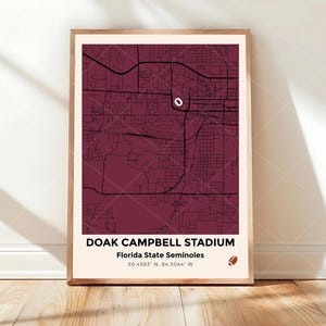 May include: Framed map print of Doak Campbell Stadium, home of the Florida State Seminoles, in a maroon color. The map shows the stadium's location with coordinates and a football graphic. The frame is a light wood color.