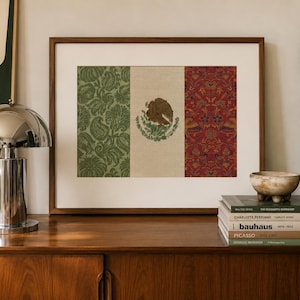 May include: A framed rectangular print featuring the Mexican flag design. The left panel is green with a floral pattern, the center is cream with the central eagle emblem, and the right panel is red with a detailed floral and bird pattern.