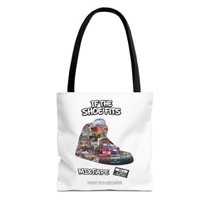 May include: A white tote bag with black handles featuring a graphic of a sneaker silhouette filled with various small images. The text reads IF THE SHOE FITS, MIXTAPE VOL. 1, and WEST 6TH RECORDS. The design includes a collage of scenes inside the shoe shape.