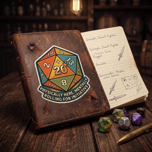 May include: A brown leather-bound notebook featuring a sticker of a twenty-sided die with the text "Physically here, mentally rolling for initiative." The open pages show handwritten character names, sword illustrations, and a map. Polyhedral dice and a pen lie nearby.