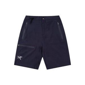 May include: Navy blue shorts with multiple zippered pockets and a drawstring waist. The shorts feature a small white logo on the left leg. These shorts are designed for outdoor activities and are made of a durable, lightweight material.