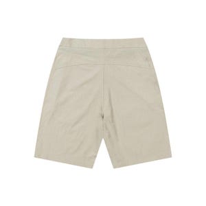 May include: A pair of beige shorts, viewed from the back. The shorts have a high waist and a relaxed fit, with a simple design. The fabric appears to be a lightweight material, suitable for warm weather. The shorts are a neutral color.