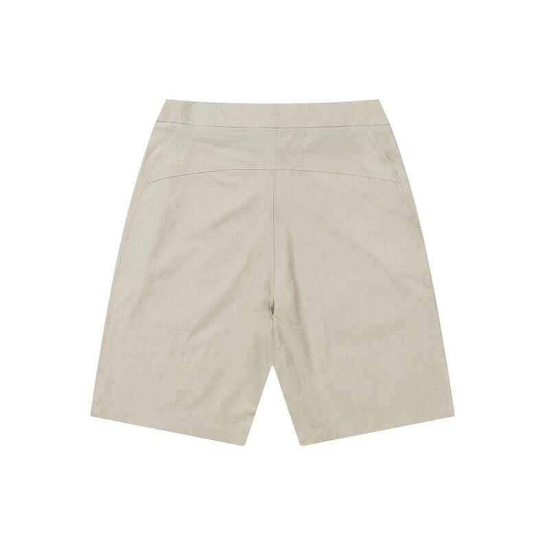 May include: A pair of beige shorts, viewed from the back. The shorts have a high waist and a relaxed fit, with a simple design. The fabric appears to be a lightweight material, suitable for warm weather. The shorts are a neutral color.