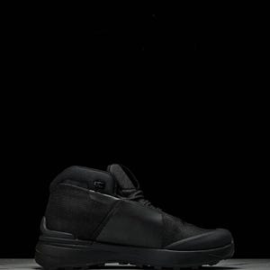 May include: Black hiking boot with a high-top design. The boot features a mesh and leather upper, a padded collar, and a thick, textured sole. The boot is designed for outdoor activities and provides ankle support.