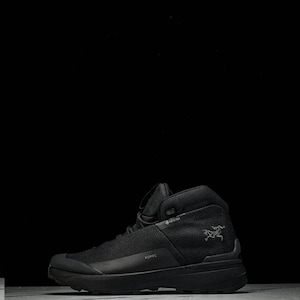 May include: Black high-top hiking boot. The boot has a mesh upper and a thick sole. The word "KOPIC" is printed on the side. A bird logo is visible on the side of the boot. The boot is designed for outdoor activities.