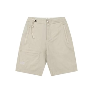 May include: Beige shorts with multiple pockets and a zip closure. The shorts have a relaxed fit and a drawstring waist. The shorts have a small logo on the left pocket. The shorts are made of a lightweight material.