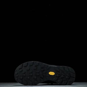 May include: Black hiking boot sole with a textured pattern and a yellow Vibram logo. The sole is designed for grip and durability, suitable for outdoor activities and rugged terrain.