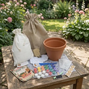 May include: A terracotta flower pot, a large hessian drawstring bag, a smaller white canvas drawstring bag, a set of small paint pots in various colours, two white paint palettes, paintbrushes, two floral stencils, and a thank you card.