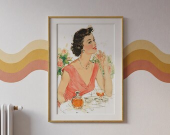 May include: A framed wall art print featuring a vintage-style illustration of a person with dark hair wearing a coral-pink dress and a pearl necklace. The person sits at a table with a glass of amber liquid and a matching decanter, surrounded by flowers.