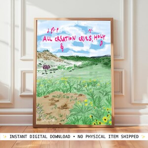 May include: A framed art print featuring a landscape painting with a blue sky and rolling green hills. The artwork includes the text "ALL CREATION CRIES, HOLY" in pink, along with musical notes. The foreground shows a field of yellow flowers.