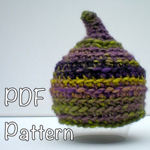 May include: A PDF pattern for crocheting a purple, green, and yellow hat with a pointed top. The hat is displayed on a clear stand.