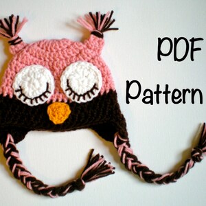 May include: Crochet pattern for an owl hat with pink and brown yarn. The hat has a braided tail and the owl's eyes are closed. The text "PDF Pattern" is visible in the image.