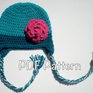 May include: A teal blue crocheted hat with a pink flower and long teal blue and white braided ties. PDF pattern.