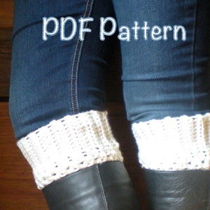 May include: Cream-colored crochet boot cuffs worn over black boots and under blue jeans. The cuffs are visible at the ankles. The text "PDF Pattern" is written in white script across the top of the image.