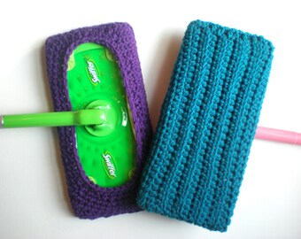 May include: Two handmade crochet mop covers. One is purple and fits a Swiffer mop head. The other is teal and rectangular. The mop covers are designed to be reusable and eco-friendly.