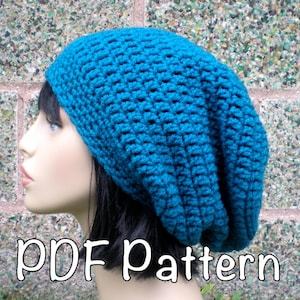May include: A teal blue crocheted beanie hat with a slouchy fit. The hat is being worn by a mannequin with black hair. The text "PDF Pattern" is written in white at the bottom of the image.