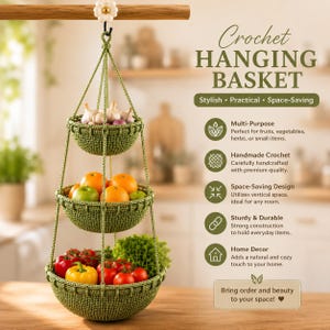 May include: A three-tiered green crochet hanging basket suspended from a wooden rod with a white flower hook. The baskets contain garlic, oranges, apples, tomatoes, and lettuce. Text on the right reads: Crochet HANGING BASKET, Stylish, Practical, Space-Saving, Multi-Purpose, Handmade Crochet, Space-Saving Design, Sturdy & Durable, Home Decor, Bring order and beauty to your space!